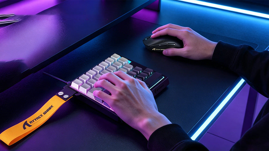 ATTACK SHARK one-handed gaming keyboard with RGB lighting used in a purple gaming desk setup