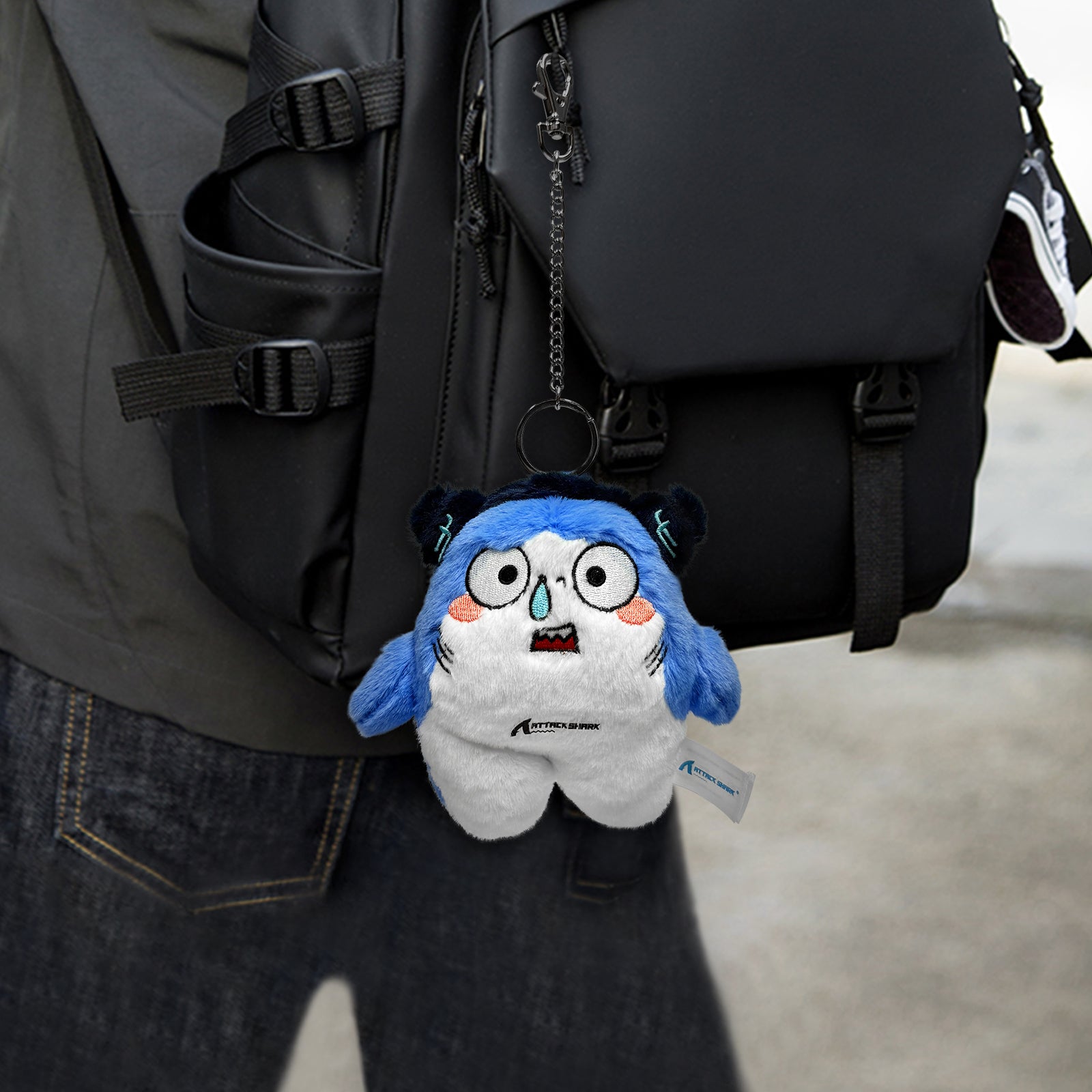 Attack Shark Mascot Plush attached to backpack