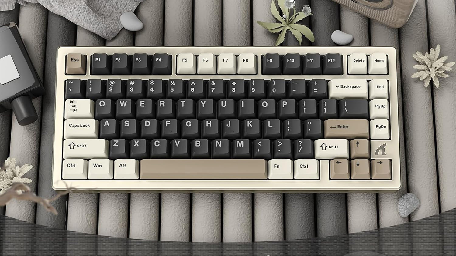 A white mechanical keyboard with black and beige keycaps is displayed on a wooden surface. 